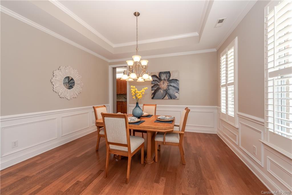 872 Treasure Court Fort Mill, SC 29708 - Photo 5 of 42 a dining room with furniture a chandelier and wooden floor
