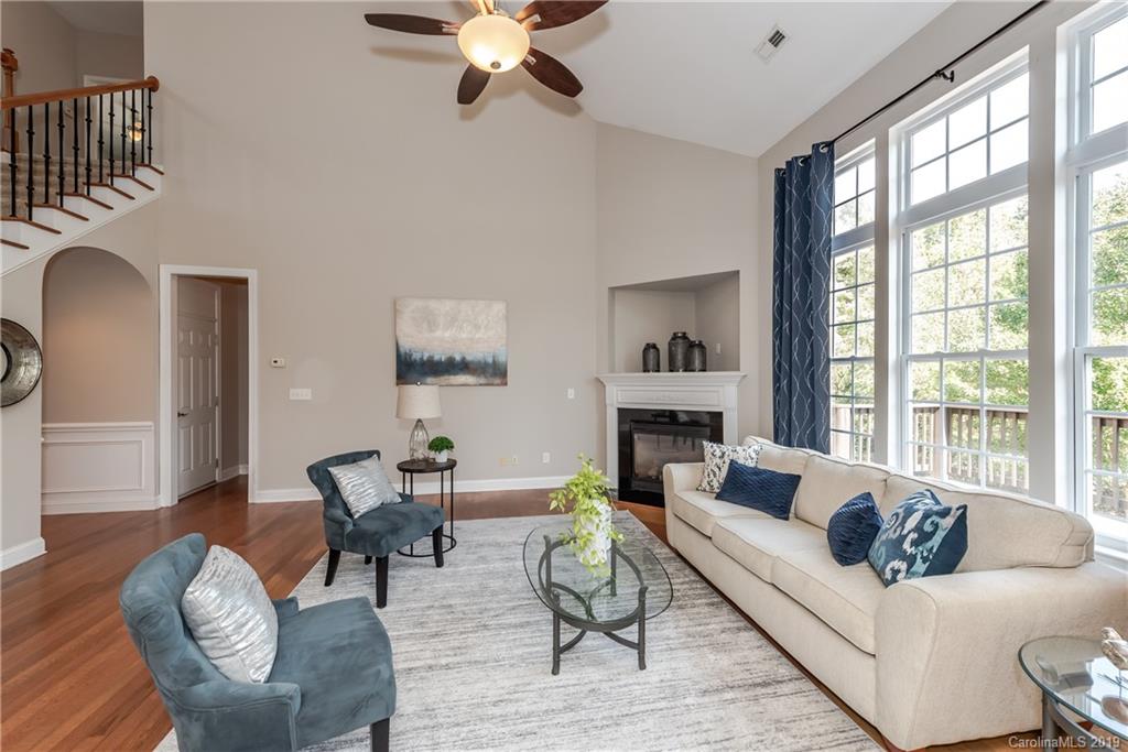 872 Treasure Court Fort Mill, SC 29708 - Photo 7 of 42 a living room with furniture a fireplace and a large window