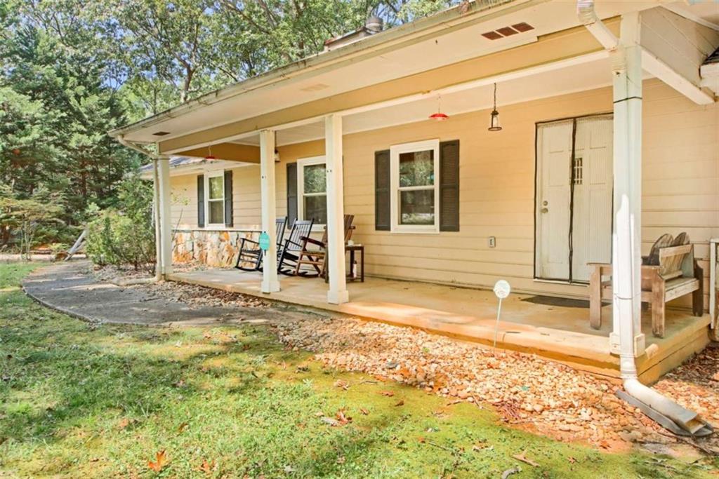 a view of a house with backyard and sitting area
