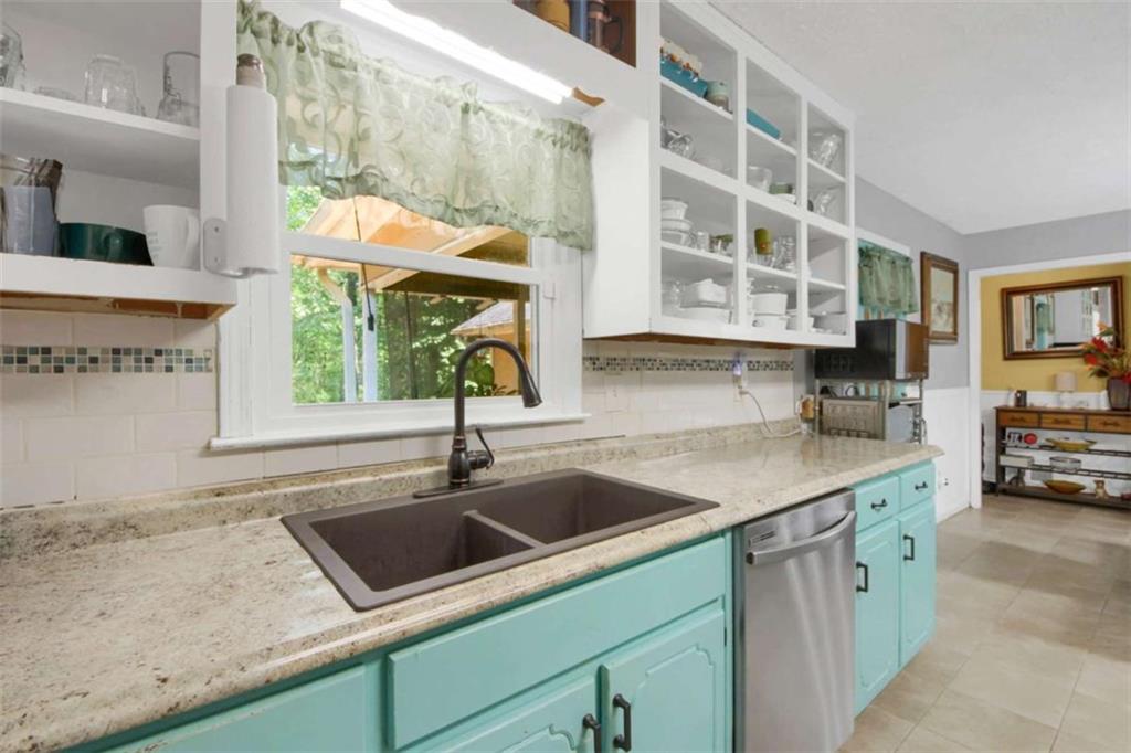 112 Bridget Drive Hampton, GA 30228 - Photo 11 of 26 a kitchen with a sink a counter top space and cabinets