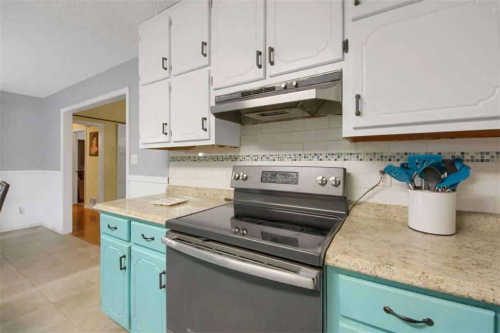 112 Bridget Drive Hampton, GA 30228 - Photo 12 of 26 a kitchen with stainless steel appliances granite countertop white cabinets and a stove