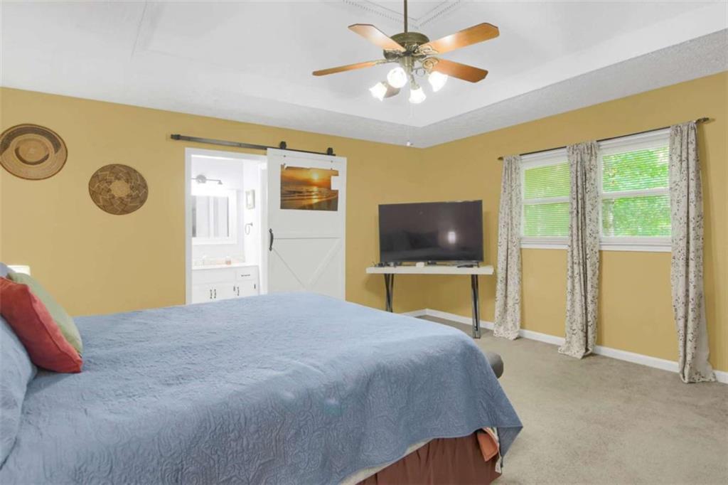 112 Bridget Drive Hampton, GA 30228 - Photo 16 of 26 a bedroom with a bed and a flat screen tv