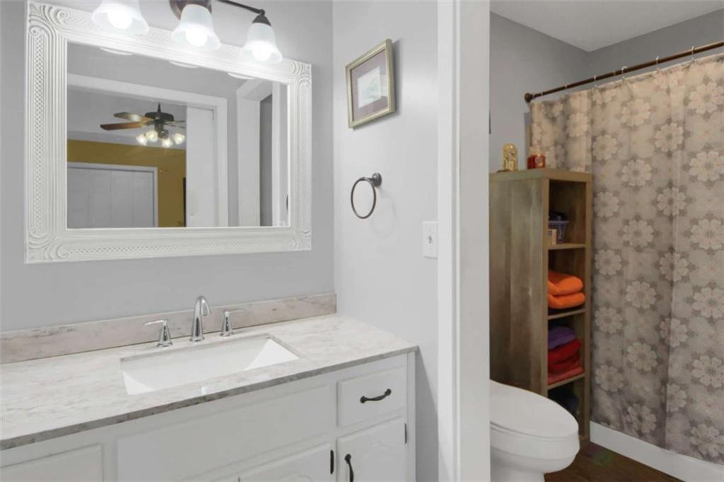 112 Bridget Drive Hampton, GA 30228 - Photo 17 of 26 a bathroom with a granite countertop sink and a mirror