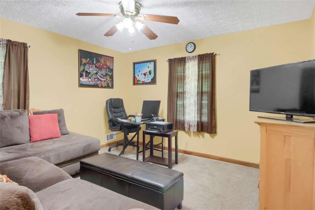 112 Bridget Drive Hampton, GA 30228 - Photo 18 of 26 a living room with furniture and a flat screen tv