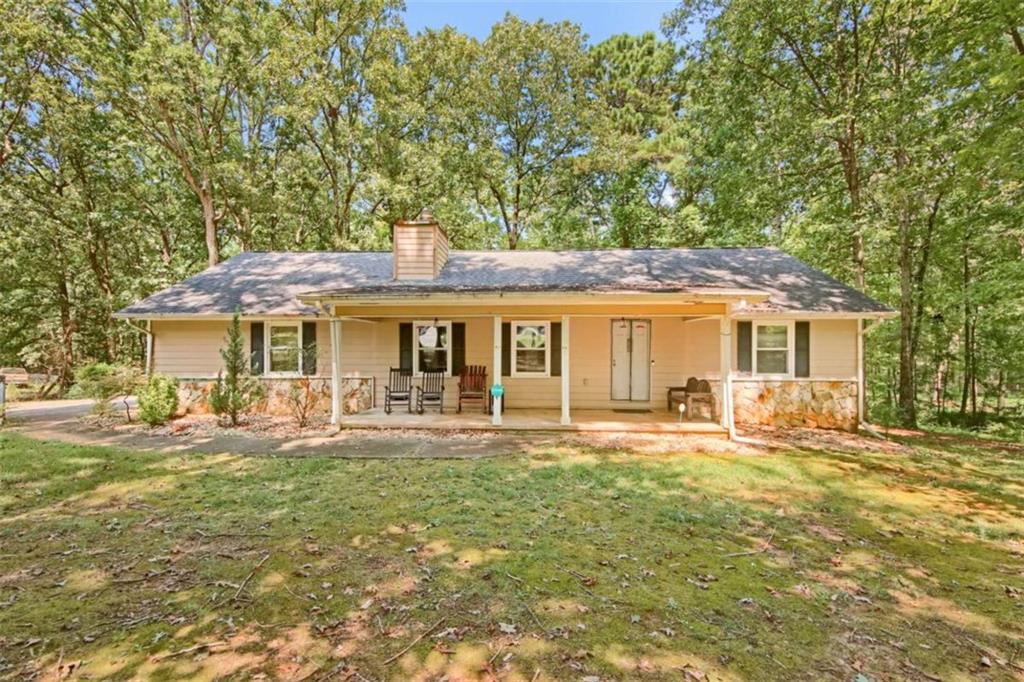 112 Bridget Drive Hampton, GA 30228 - Photo 2 of 26 a front view of a house with a yard table and chairs