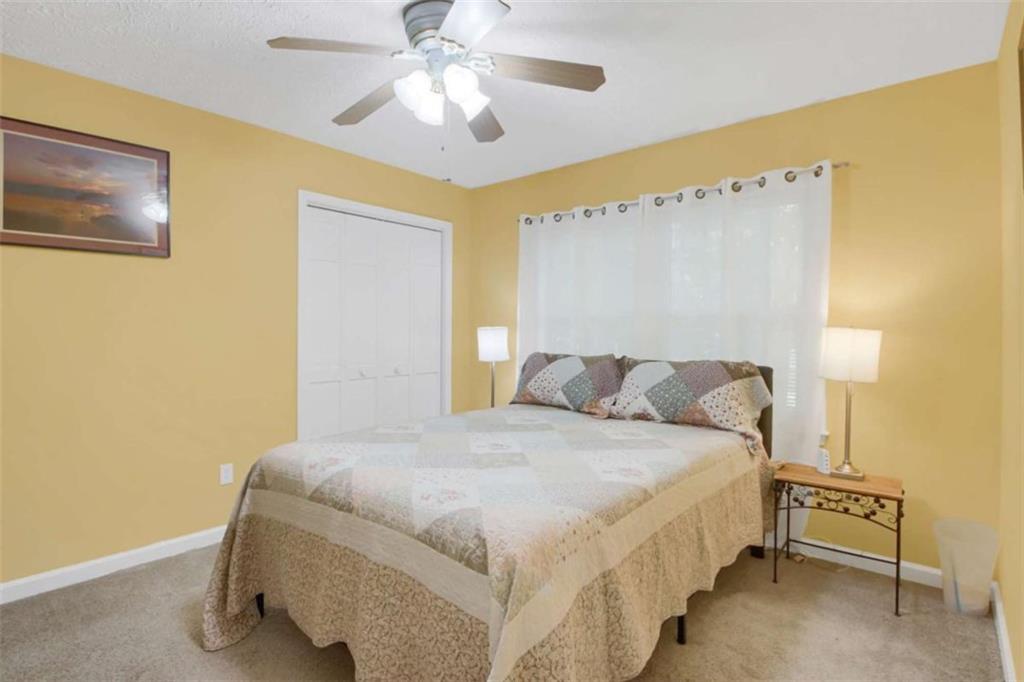 112 Bridget Drive Hampton, GA 30228 - Photo 21 of 26 a bedroom with a bed and a chandelier