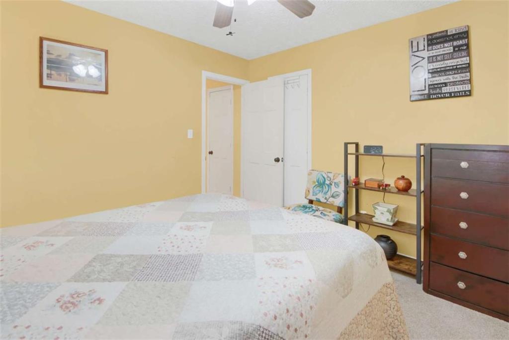112 Bridget Drive Hampton, GA 30228 - Photo 22 of 26 a bedroom with a bed and a lamp on the dresser