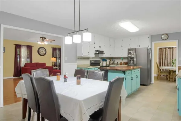 a large kitchen with a table and chairs