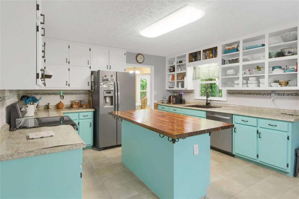 112 Bridget Drive Hampton, GA 30228 - Photo 8 of 26 a kitchen with stainless steel appliances granite countertop a sink stove and refrigerator