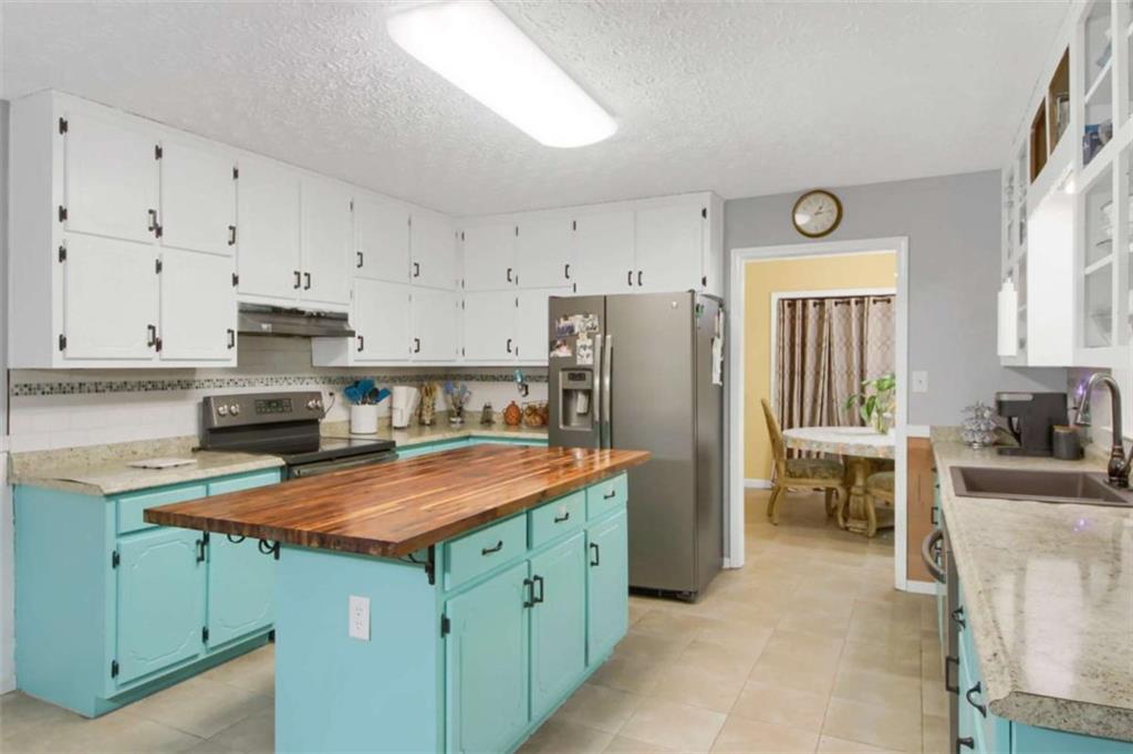 112 Bridget Drive Hampton, GA 30228 - Photo 9 of 26 a kitchen with stainless steel appliances granite countertop a stove refrigerator and cabinets