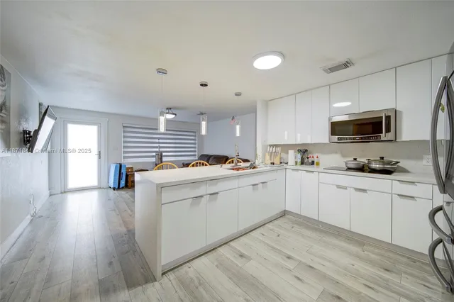 a kitchen with cabinets a sink and appliances