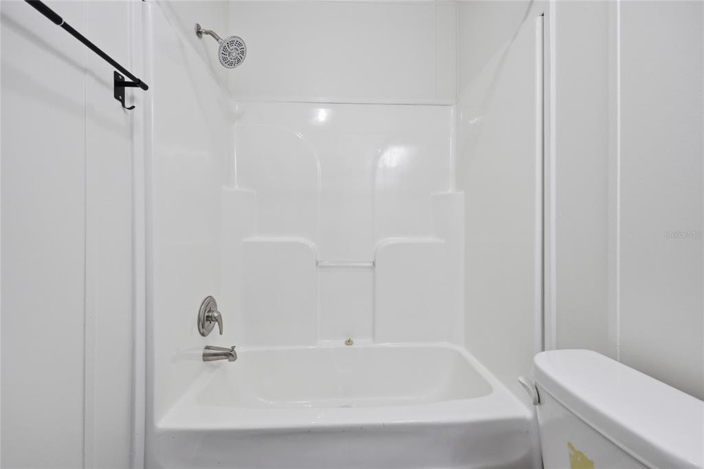 215 Southwest Alpine Place High Springs, FL 32643 - Photo 19 of 41 a white bath tub sitting next to a white toilet and sink