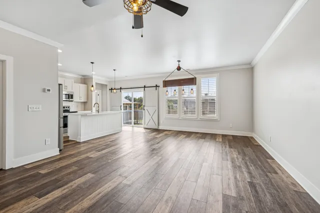 a view of wooden floor and a chandelier in a room