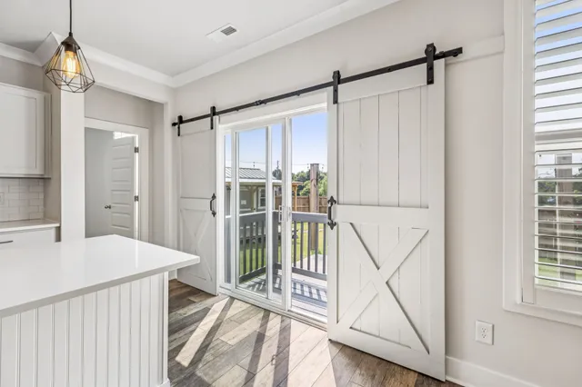 a very nice looking room with a large window and wooden floor