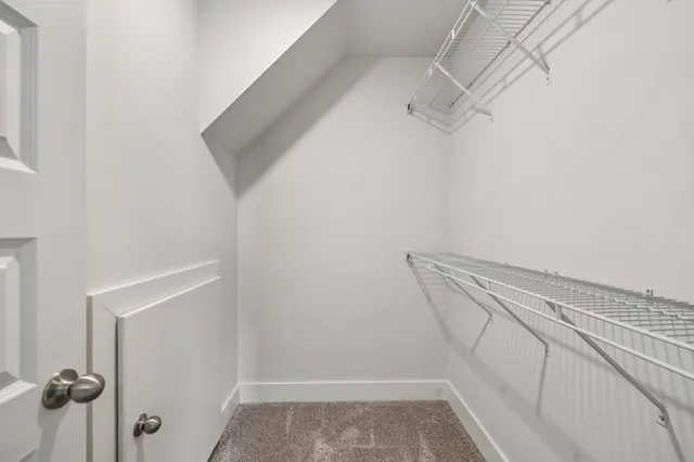 a bathroom with a granite countertop toilet sink and mirror