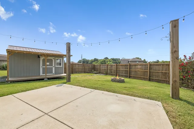 a front view of a house with a garden and yard