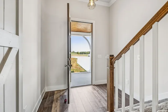 a view of an entryway with wooden floor and door