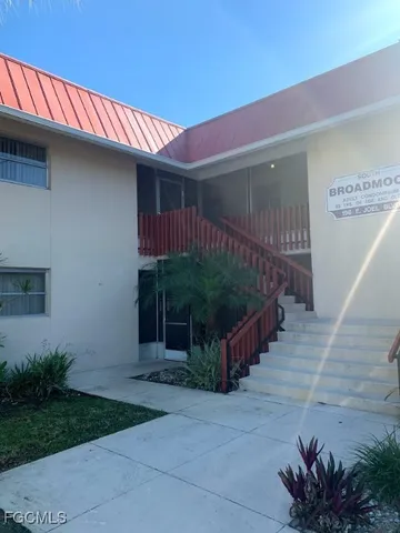 a view of a patio with table and chairs with wooden fence