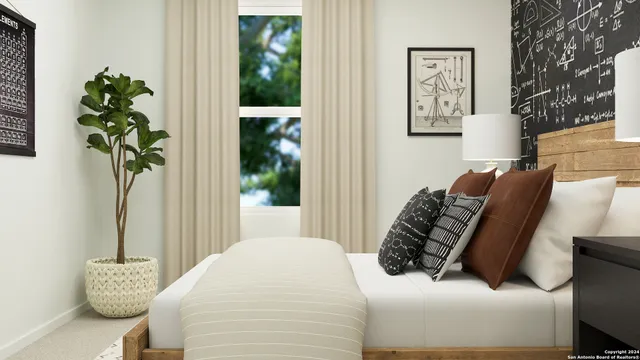 a bed sitting in a bedroom next to a window with potted plant