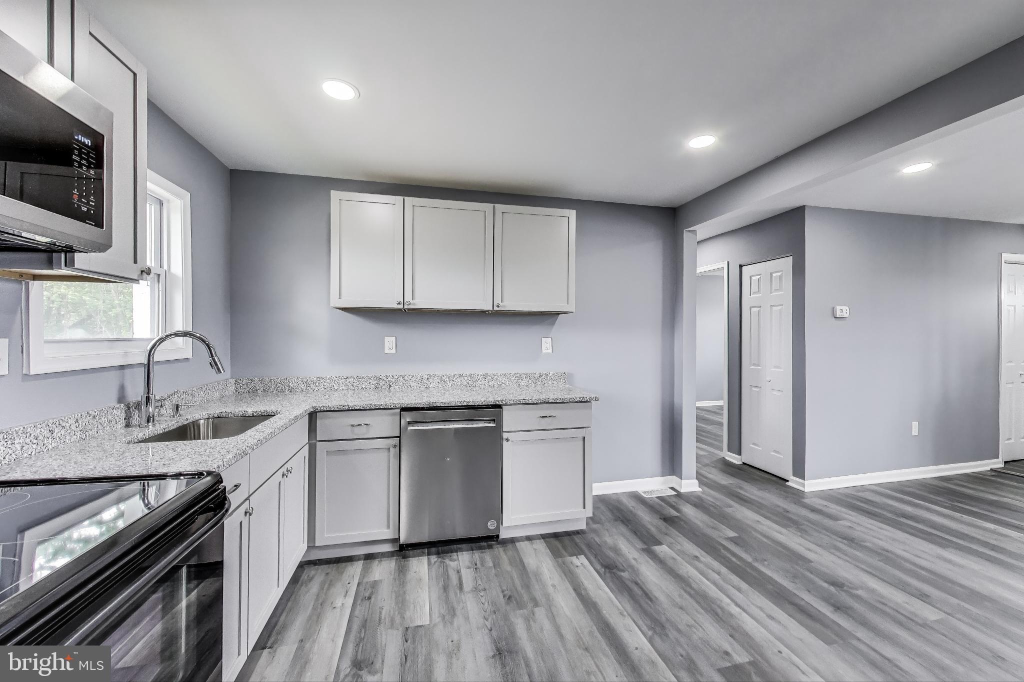 2500 Gehb Avenue Baltimore, MD 21227 - Photo 13 of 53 a kitchen with a sink stove top oven and cabinets