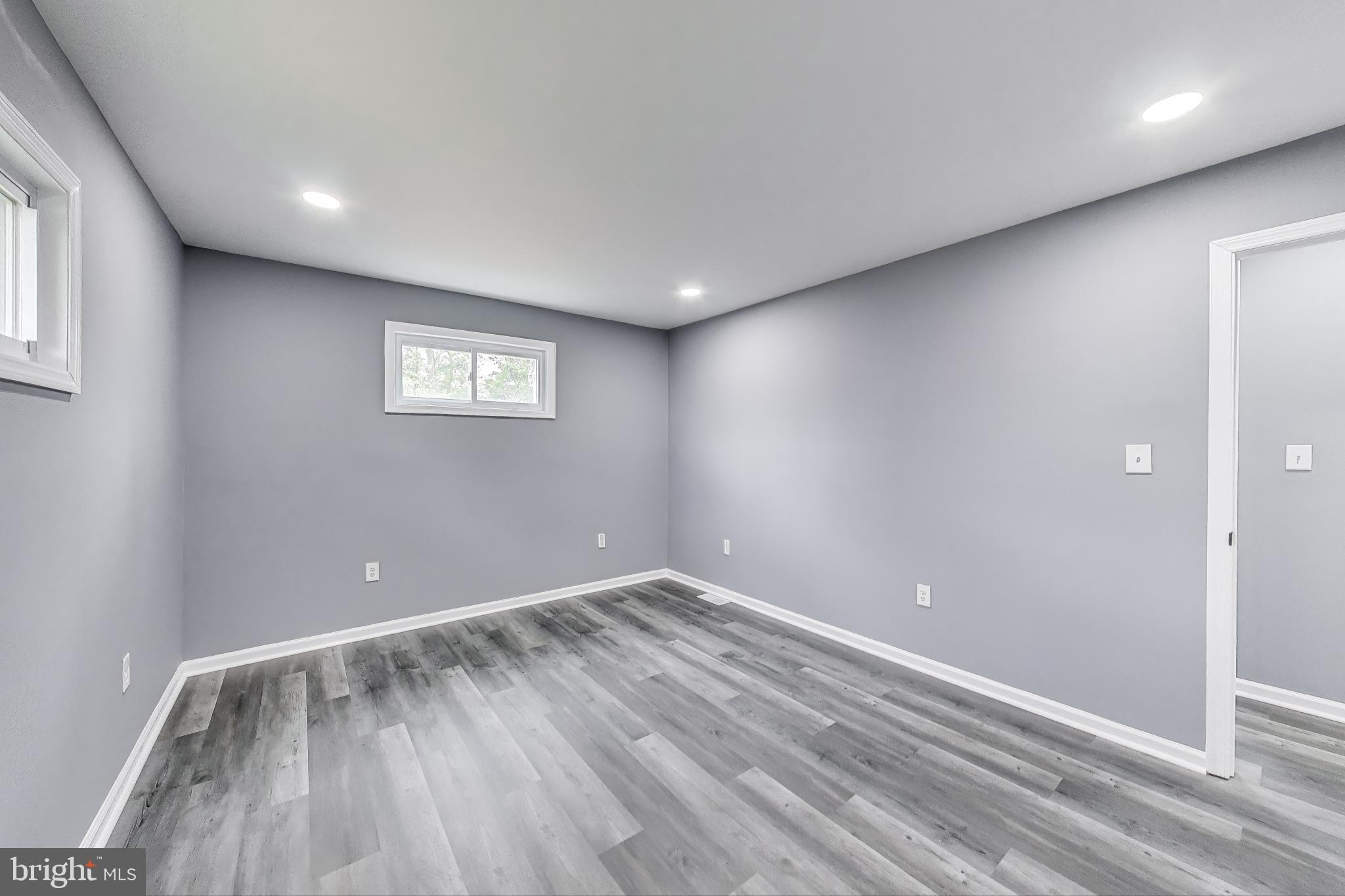 2500 Gehb Avenue Baltimore, MD 21227 - Photo 16 of 53 an empty room with wooden floor and windows