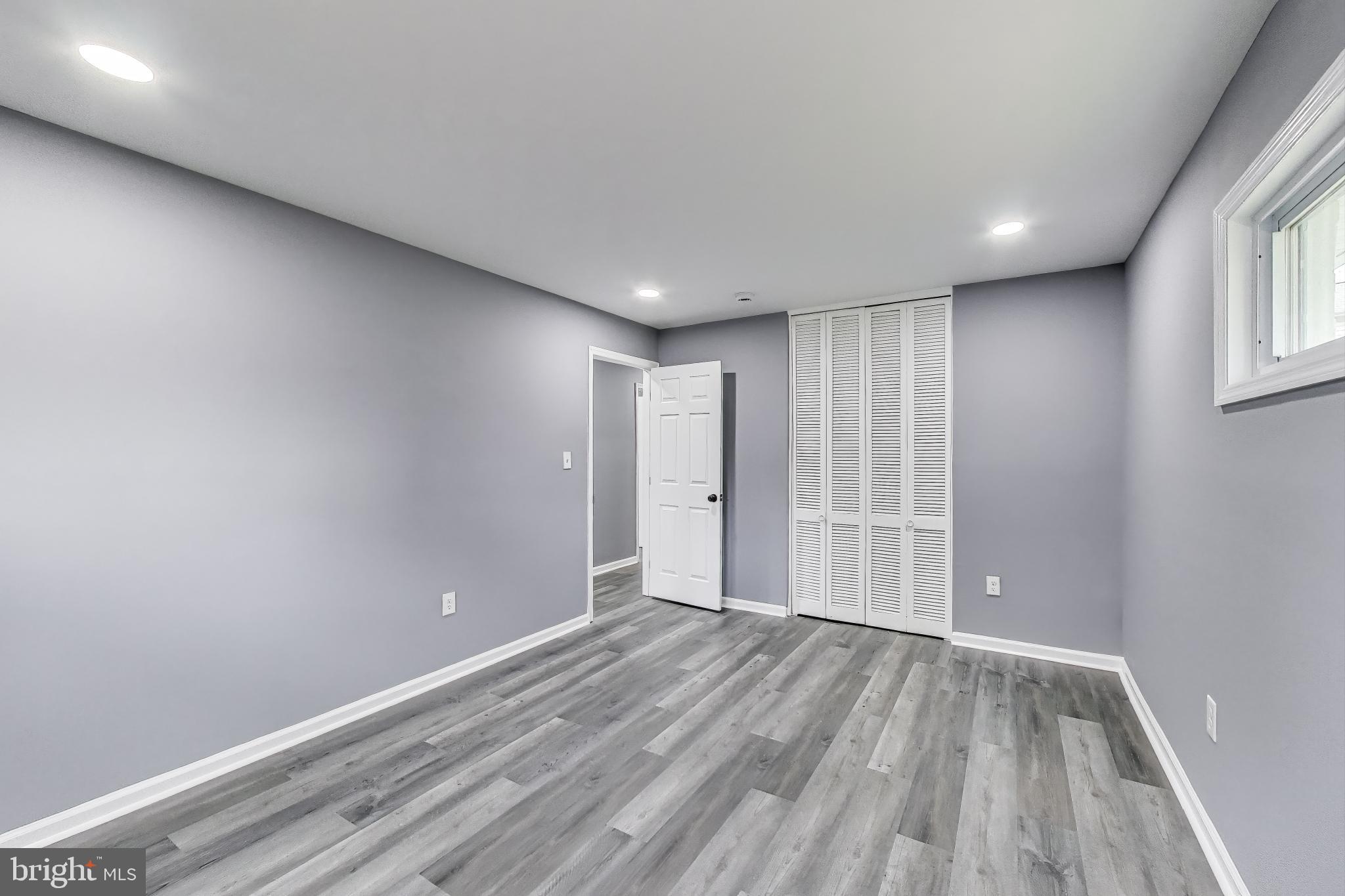 2500 Gehb Avenue Baltimore, MD 21227 - Photo 17 of 53 a view of an empty room with wooden floor and a window