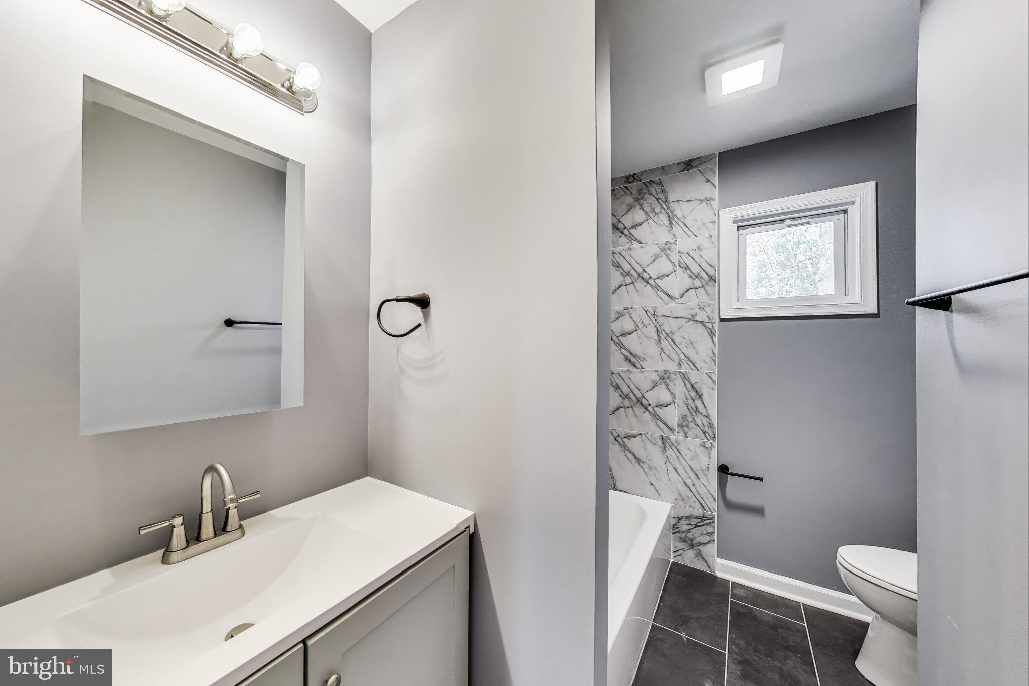 2500 Gehb Avenue Baltimore, MD 21227 - Photo 25 of 53 a bathroom with a sink a toilet a shower and a mirror