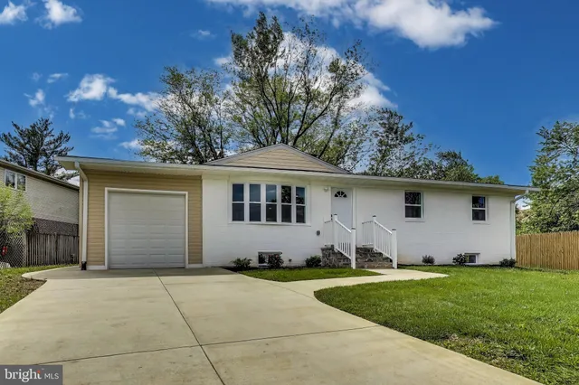 a kitchen with granite countertop a refrigerator stove and sink