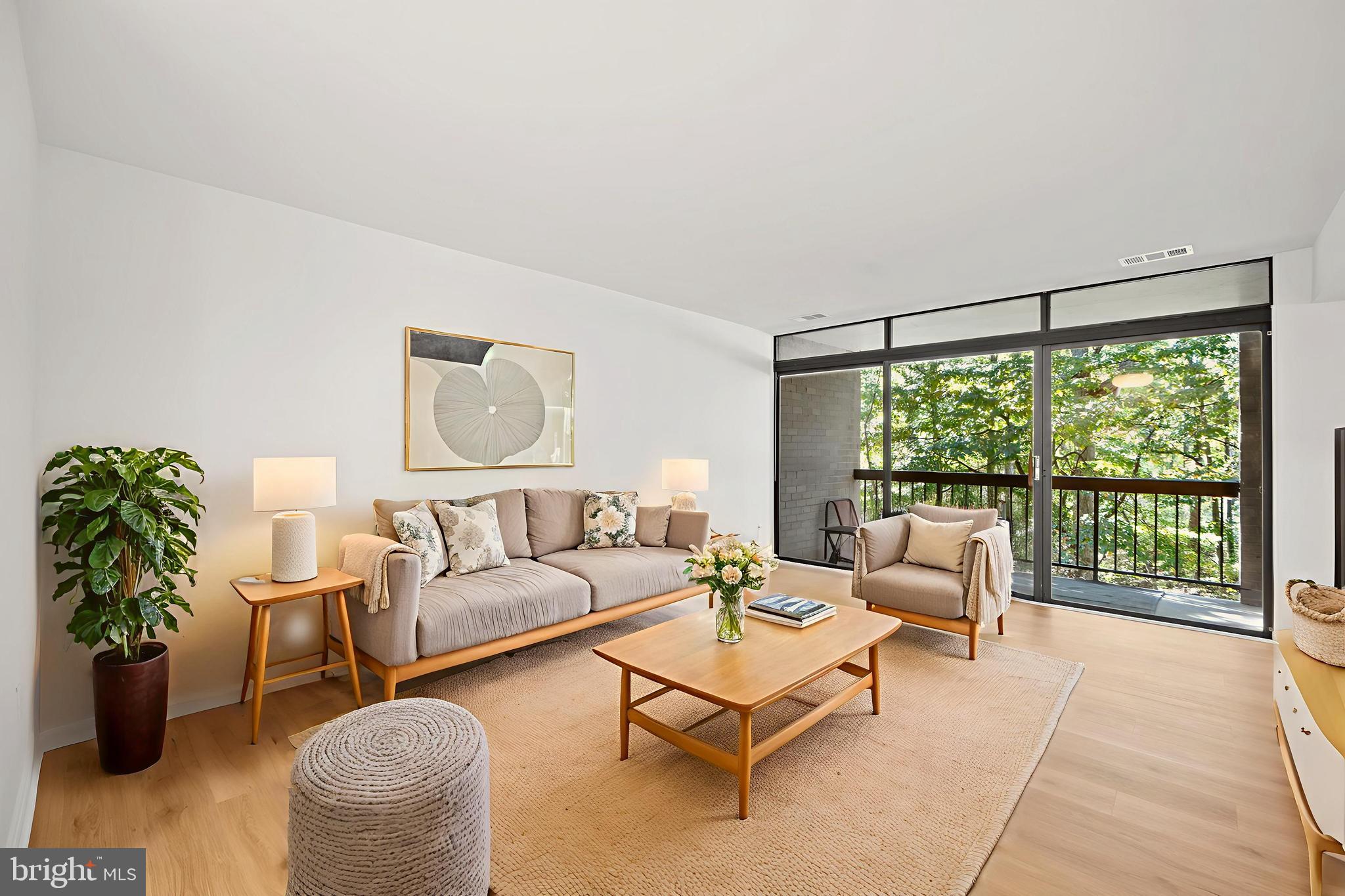 1656 Parkcrest Circle, Unit 2D/301 Reston, VA 20190 - Photo 1 of 29 a living room with furniture and a large window