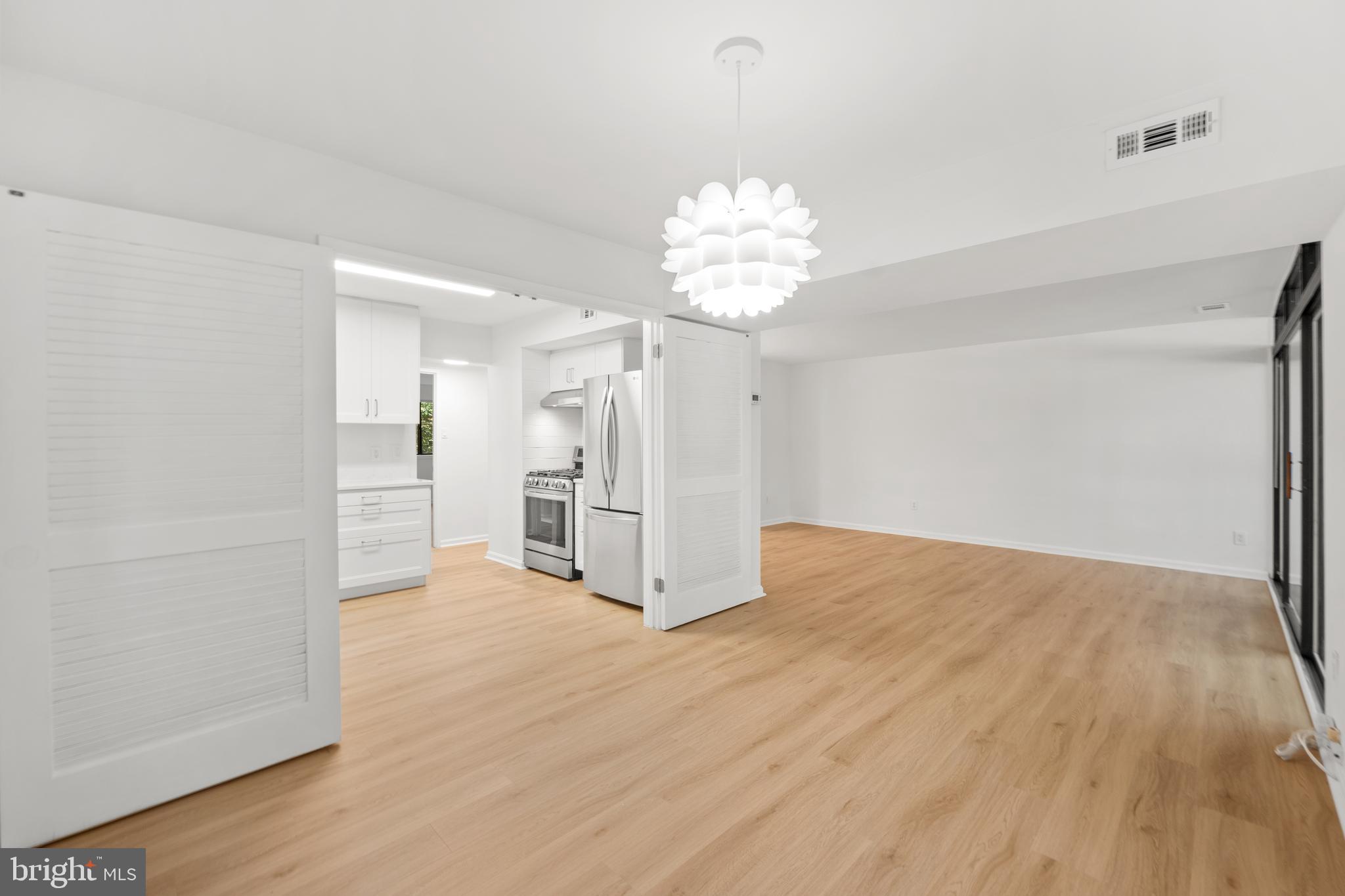 1656 Parkcrest Circle, Unit 2D/301 Reston, VA 20190 - Photo 11 of 29 wooden floor in an empty room with a chandelier