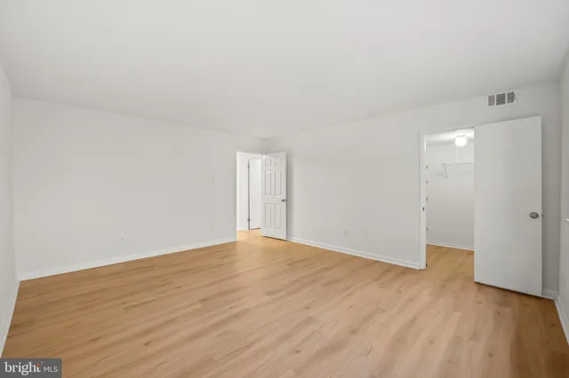 a view of an empty room and wooden floor