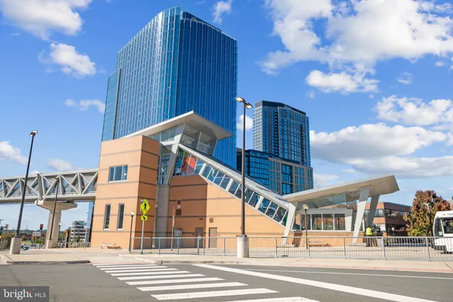 a front view of multi story building with retail shops
