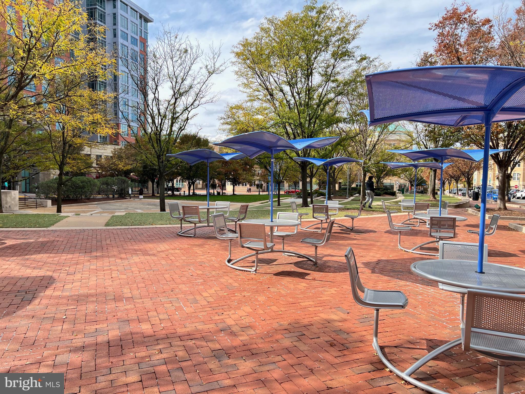 1656 Parkcrest Circle, Unit 2D/301 Reston, VA 20190 - Photo 28 of 29 a view of a swimming pool with a table and chairs under an umbrella