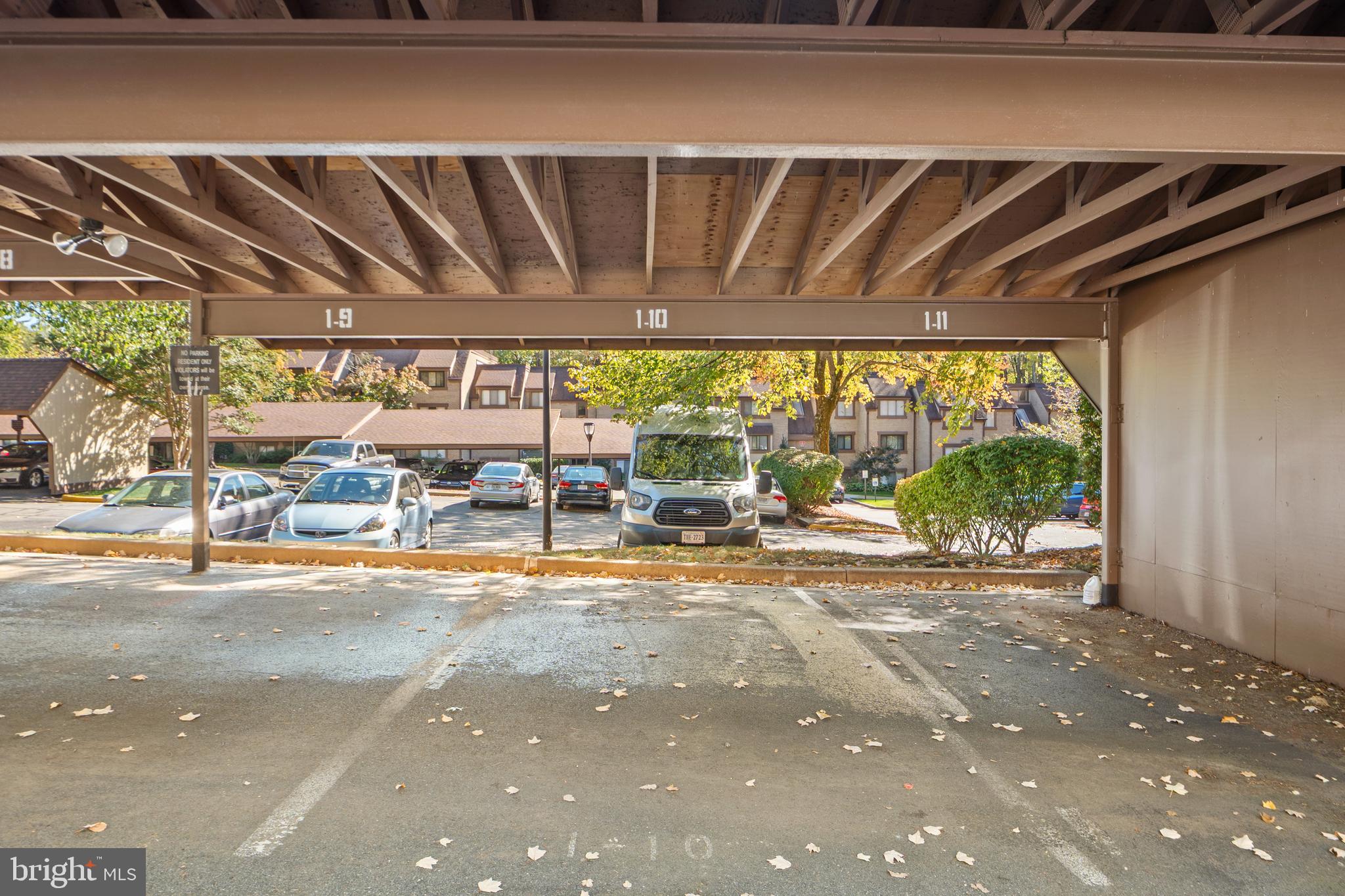 1656 Parkcrest Circle, Unit 2D/301 Reston, VA 20190 - Photo 4 of 29 a view of a patio with a table and chairs under an umbrella