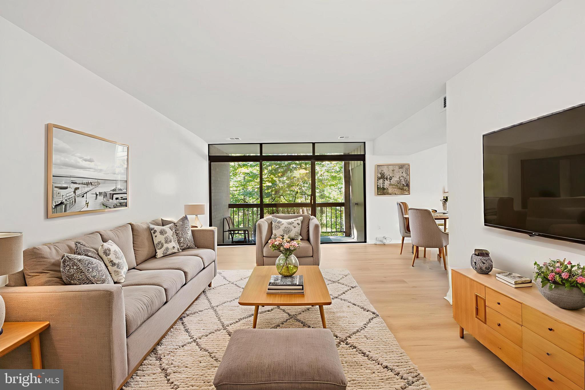 1656 Parkcrest Circle, Unit 2D/301 Reston, VA 20190 - Photo 6 of 29 a living room with furniture large window and a flat screen tv