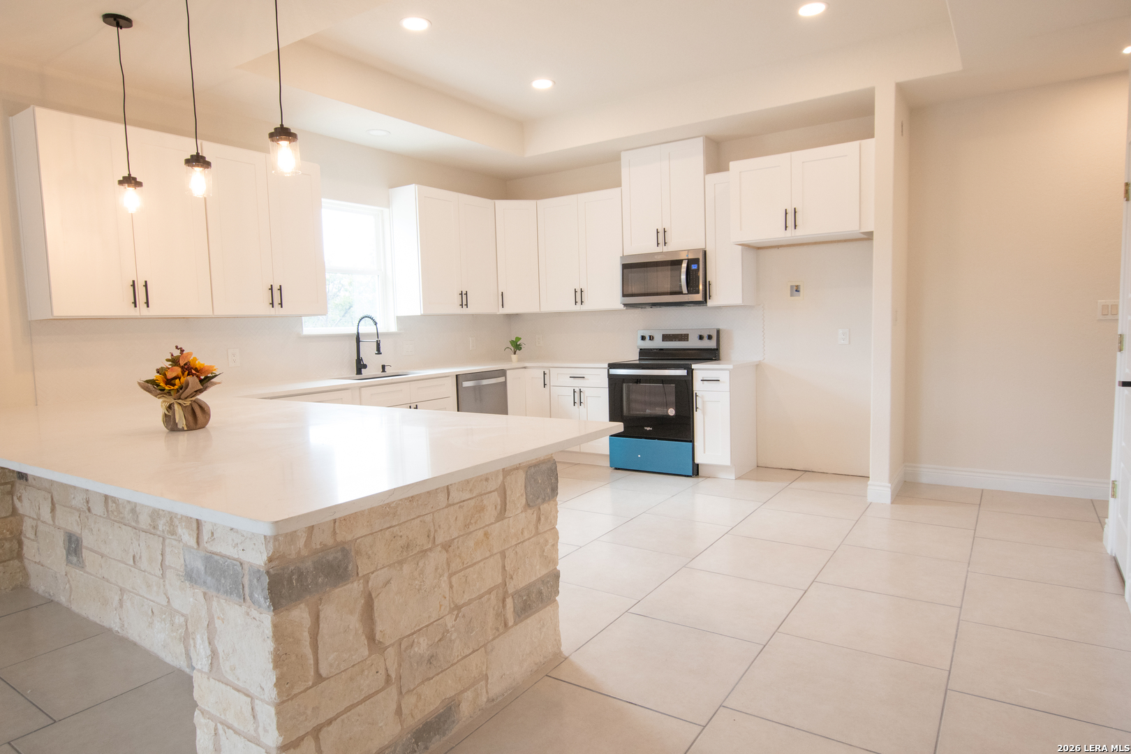 2962 Contour Drive Spring Branch, TX 78070 - Photo 12 of 34 a large kitchen with stainless steel appliances granite countertop a sink a stove and a refrigerator