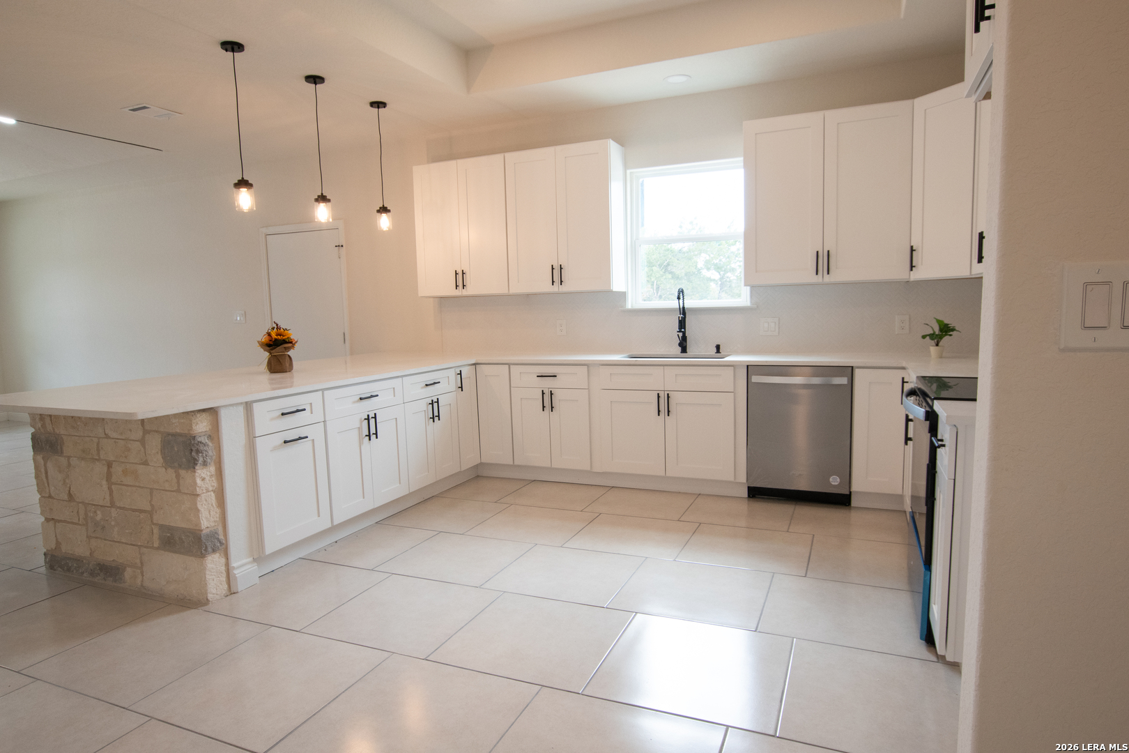 2962 Contour Drive Spring Branch, TX 78070 - Photo 13 of 34 a large white kitchen with a sink a window and stainless steel appliances