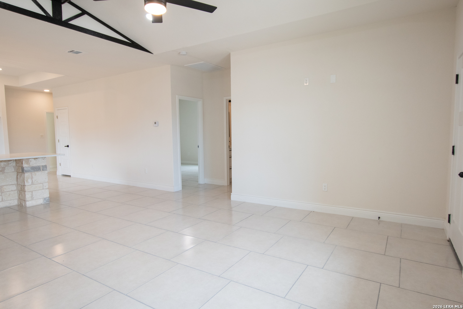 2962 Contour Drive Spring Branch, TX 78070 - Photo 8 of 34 an empty room with a ceiling fan and glass door
