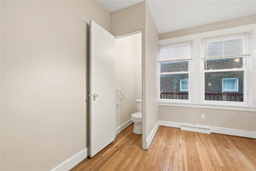 436 44th Street Pittsburgh, PA 15201 - Photo 14 of 30 a view of an empty room with wooden floor and a window