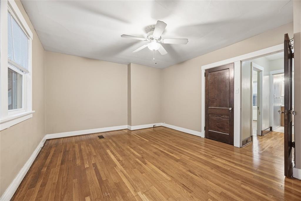 436 44th Street Pittsburgh, PA 15201 - Photo 16 of 30 a view of an empty room with wooden floor and a ceiling fan