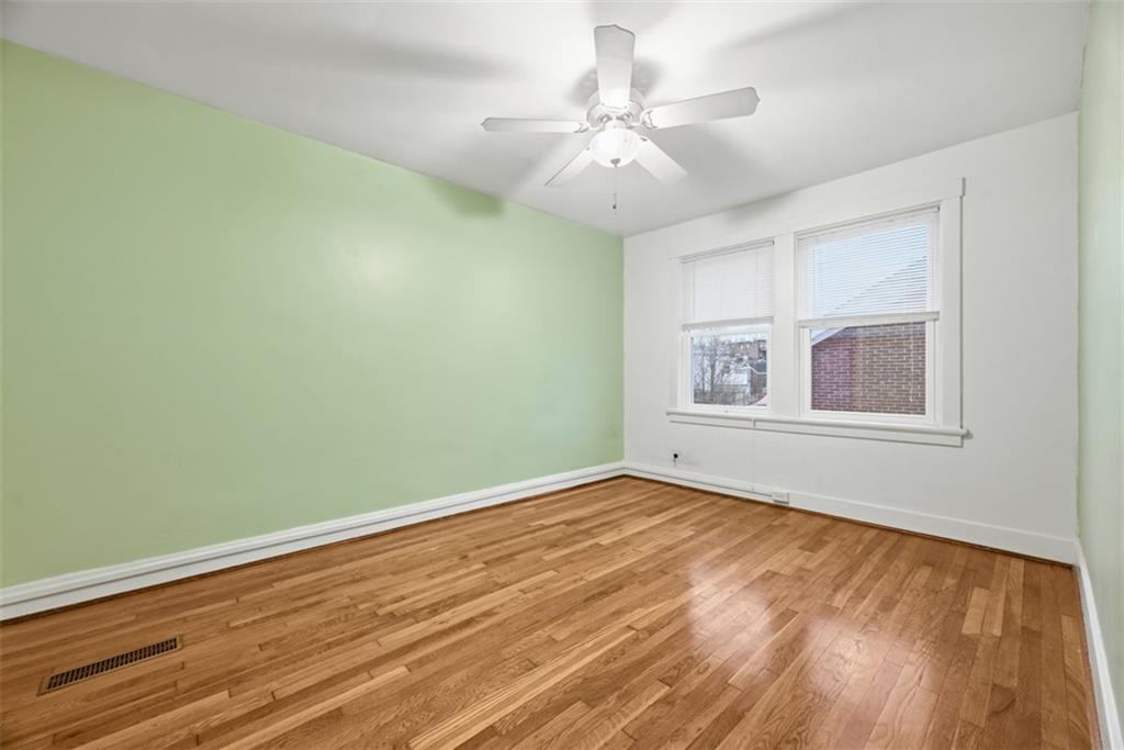 436 44th Street Pittsburgh, PA 15201 - Photo 20 of 30 a view of an empty room with wooden floor and a window