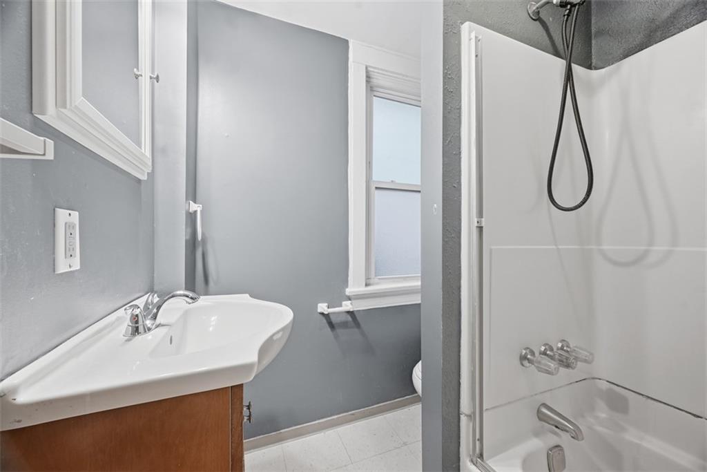 436 44th Street Pittsburgh, PA 15201 - Photo 22 of 30 a bathroom with a sink a mirror and shower