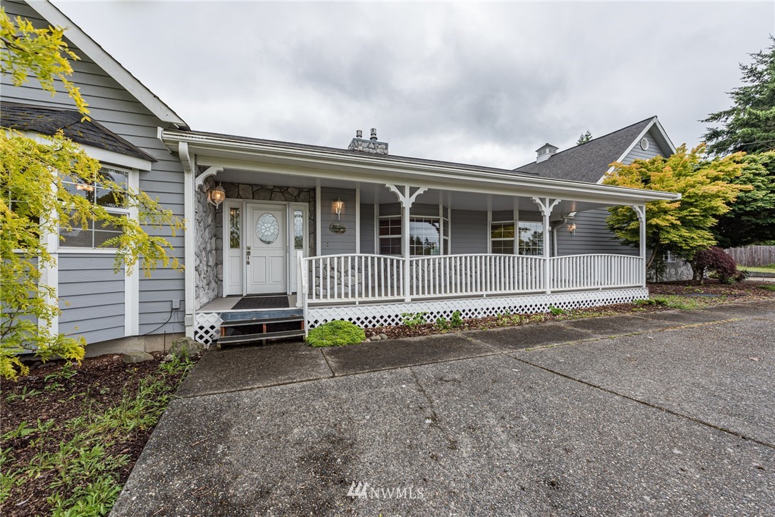 2367 Happy Valley Road Sequim, WA 98382 - Photo 1 of 39 a front view of a house with a yard and garage