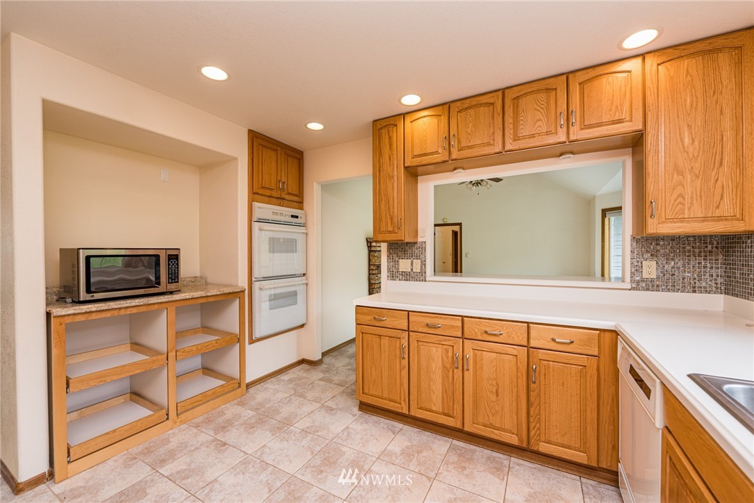 2367 Happy Valley Road Sequim, WA 98382 - Photo 5 of 39 a kitchen with cabinets and oven