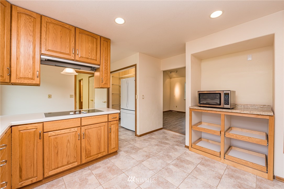 2367 Happy Valley Road Sequim, WA 98382 - Photo 7 of 39 a kitchen with stainless steel appliances granite countertop a refrigerator and microwave