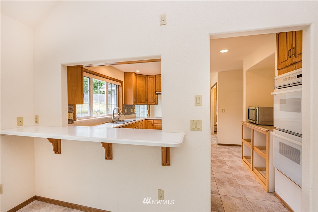 2367 Happy Valley Road Sequim, WA 98382 - Photo 9 of 39 a kitchen with stainless steel appliances granite countertop a sink and a refrigerator