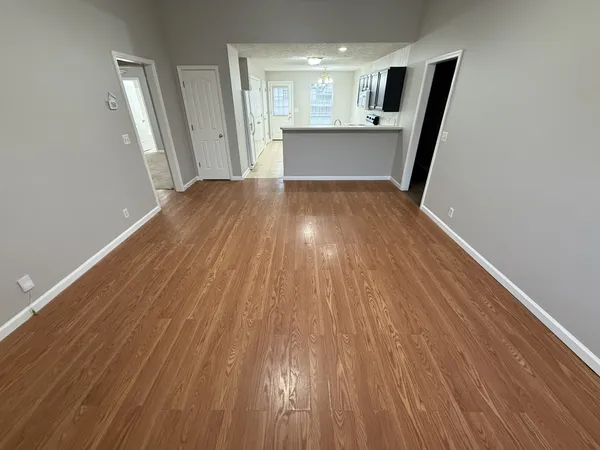 a view of a kitchen from a hallway