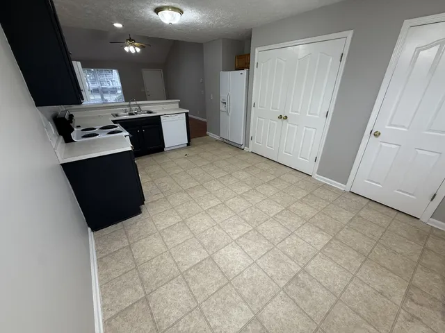 a view of kitchen with microwave and cabinets