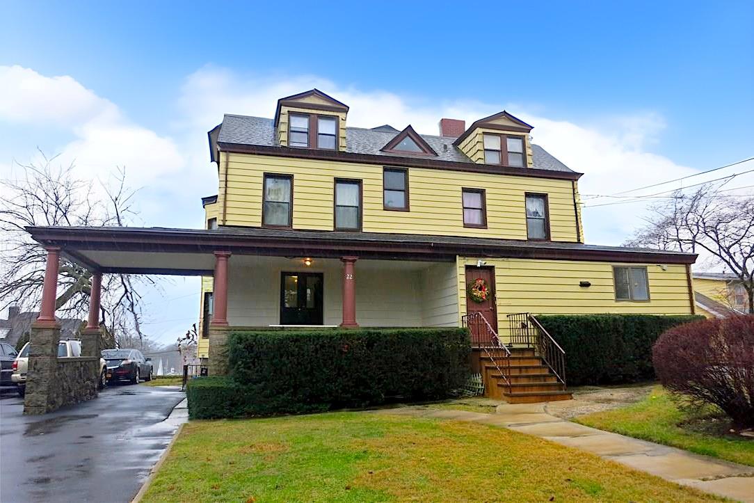 a front view of a house with garden