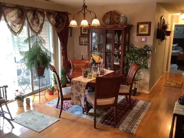 a view of a dining room with furniture and chandelier